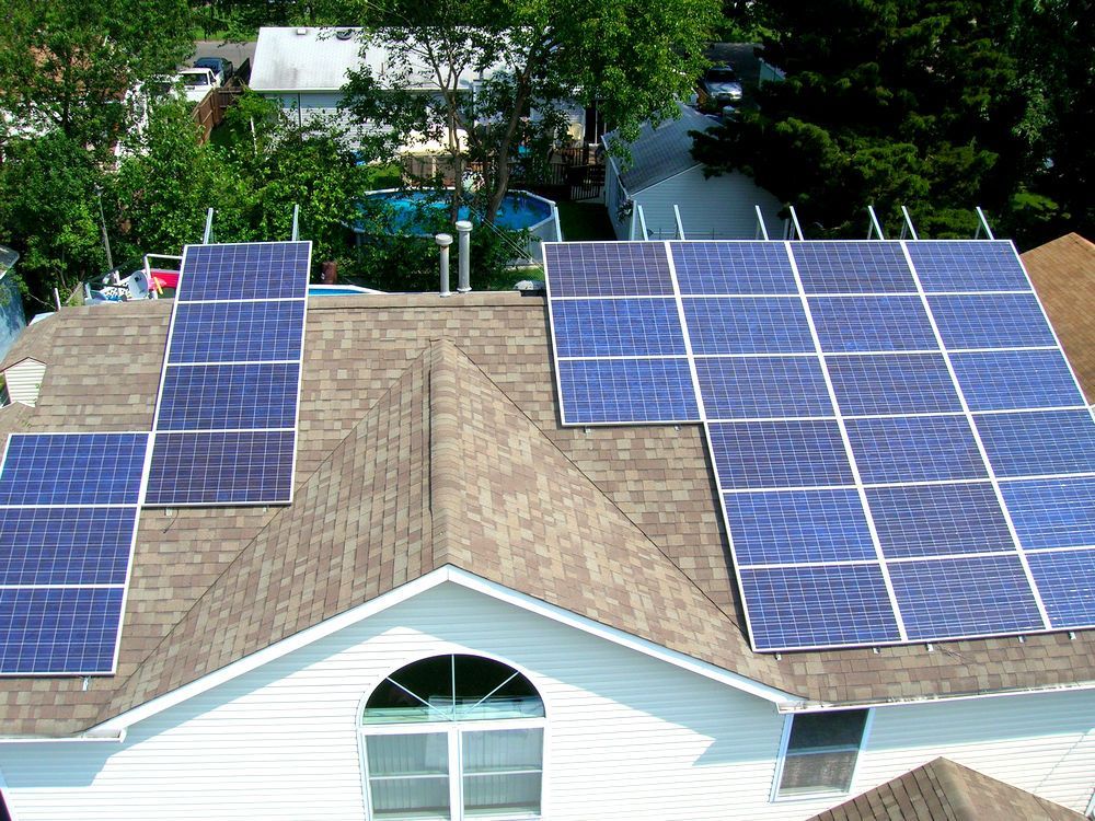 A house with a lot of solar panels on the roof.