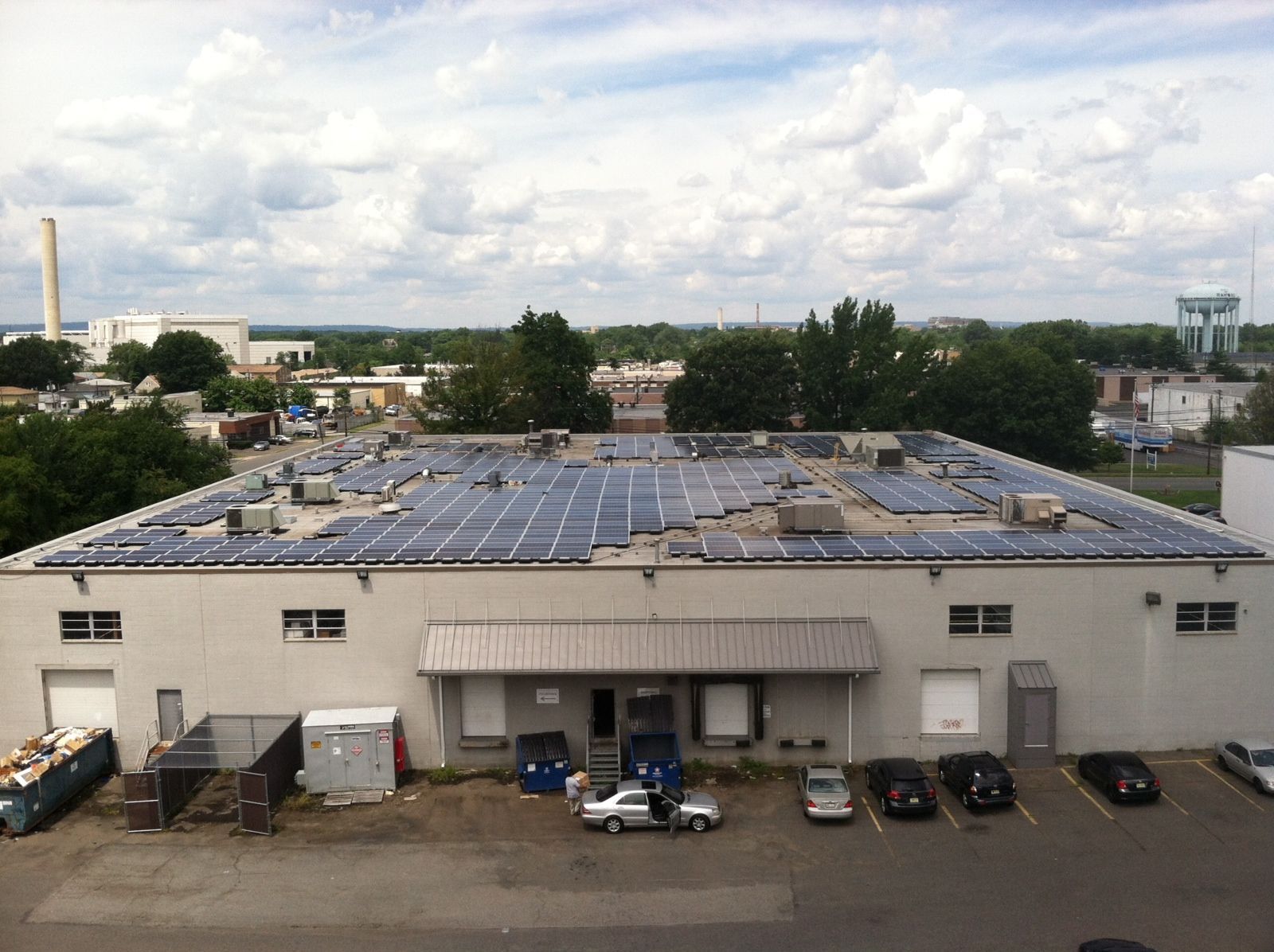 A large building with a lot of solar panels on the roof.