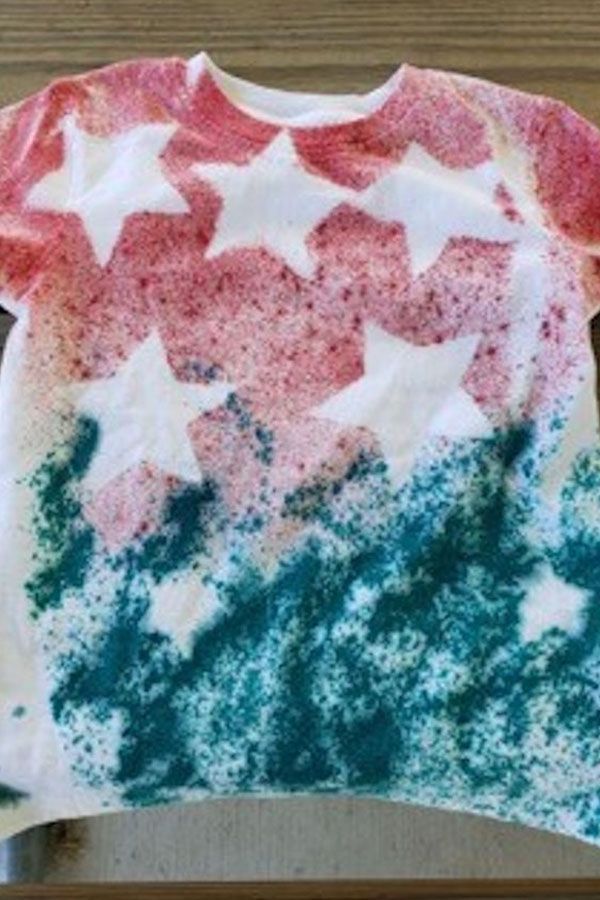 A t-shirt with stars on it is sitting on a table.