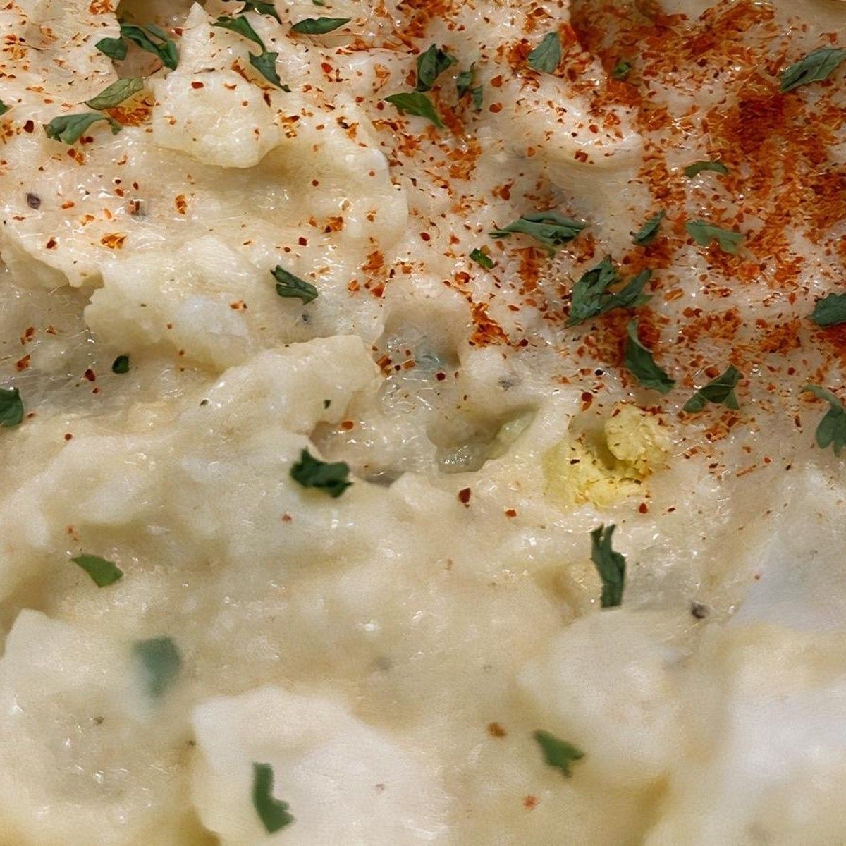 A close-up of potato salad with spices on top