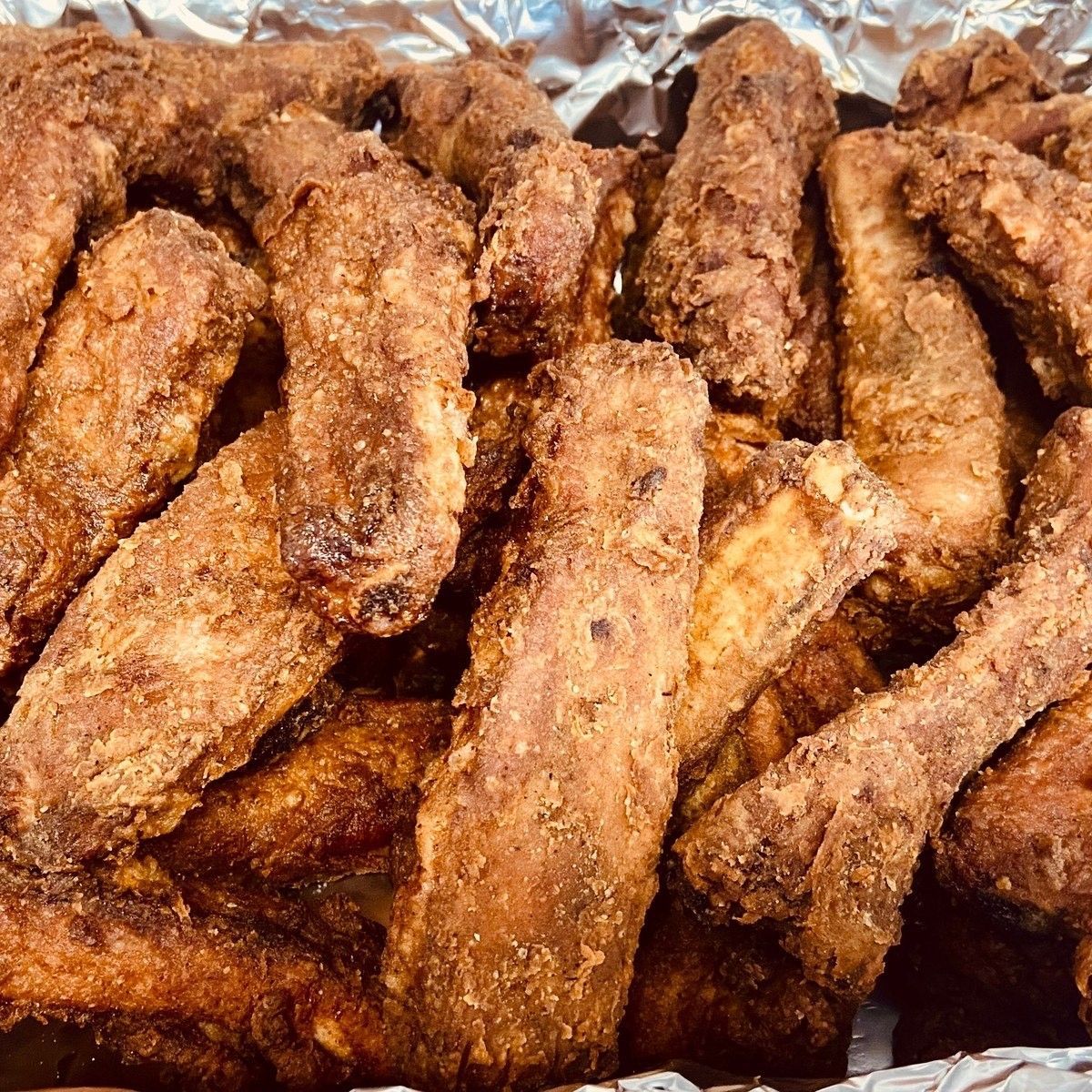 A close-up of a plate of fried baby back ribs