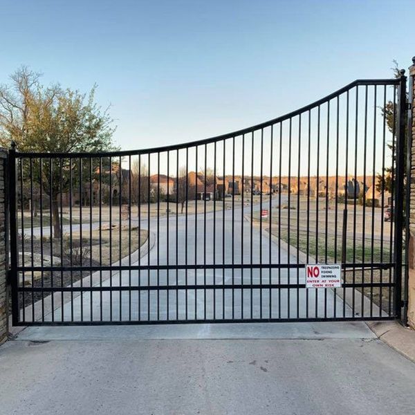 A black gate with a no entry sign on it