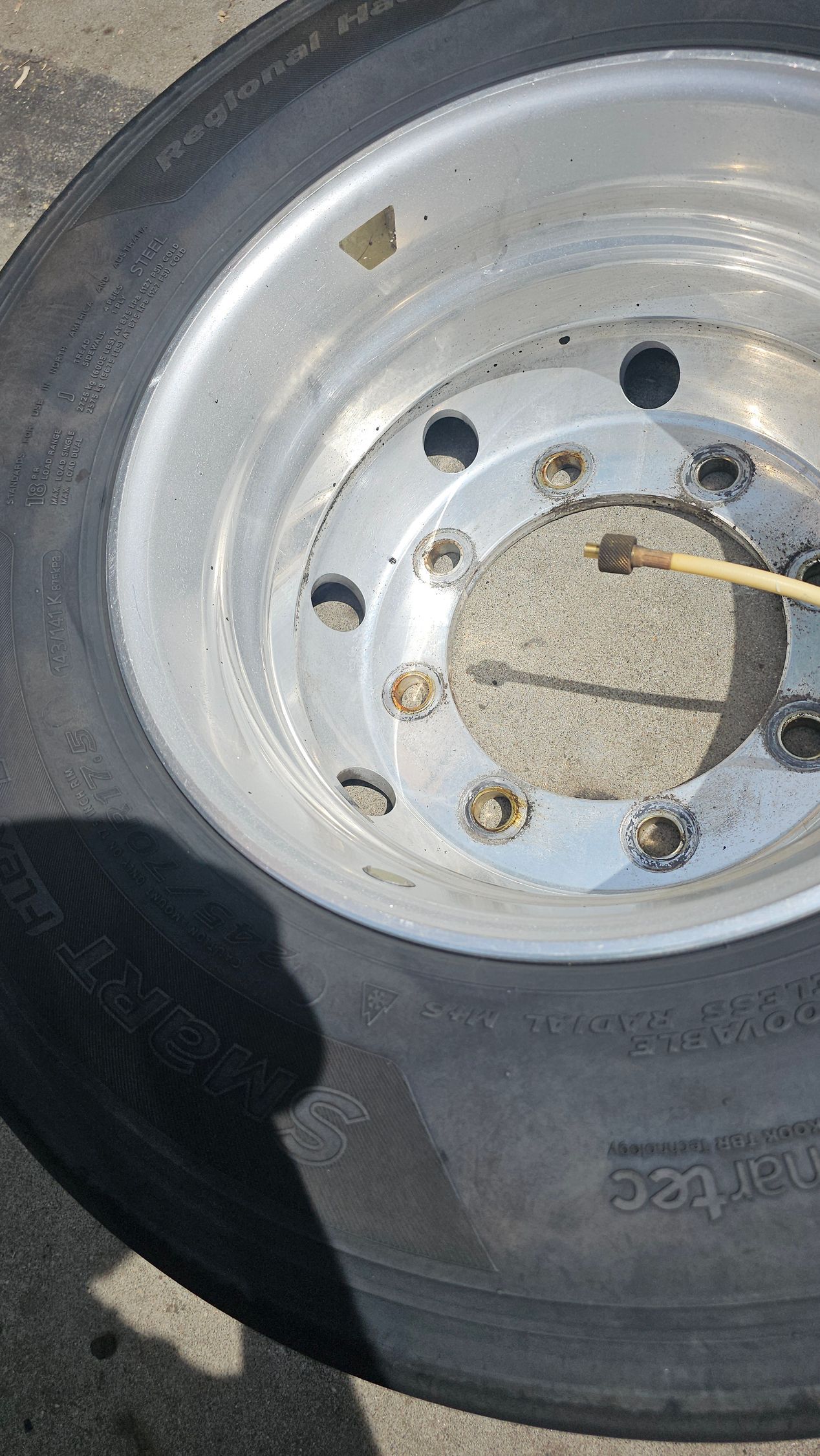 A close up of a truck tire with a metal rim.