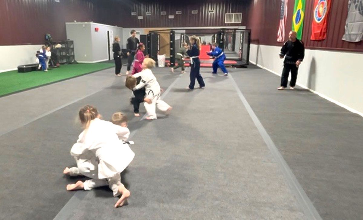 Children practicing martial arts in a gym