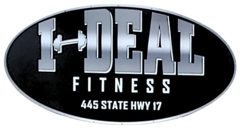 Black oval sign with "I-DEAL FITNESS" in silver letters. A barbell replaces the "L".  "445 STATE HWY 17" is at the bottom.