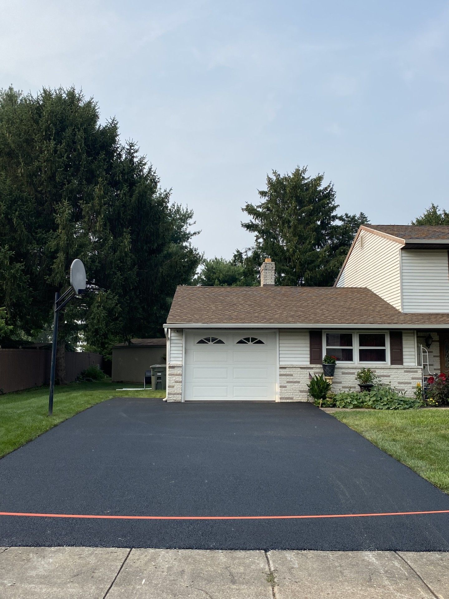 A house with a basketball hoop in front of it