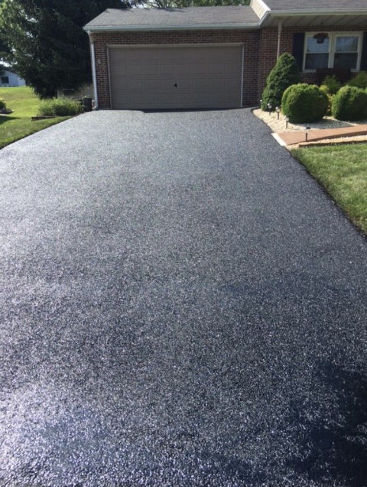 A driveway leading to a house with a garage.