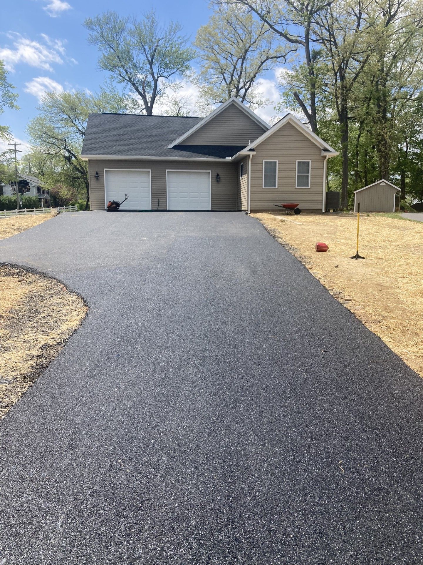 A driveway leading to a house with two garages.