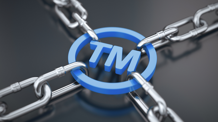 Blue TM symbol encircled by chains.