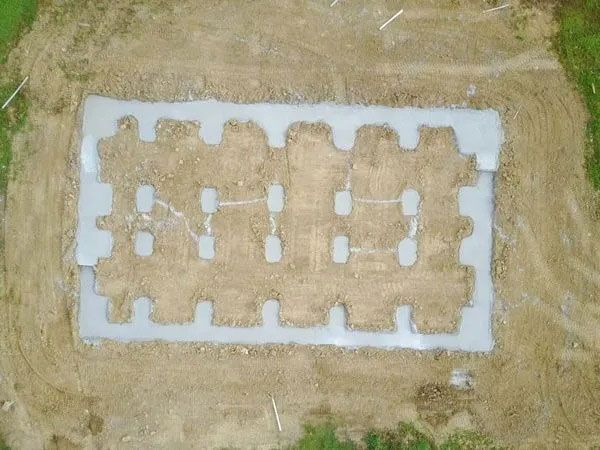 Aerial view of a white-bordered tan rectangular pattern laid on dry grass