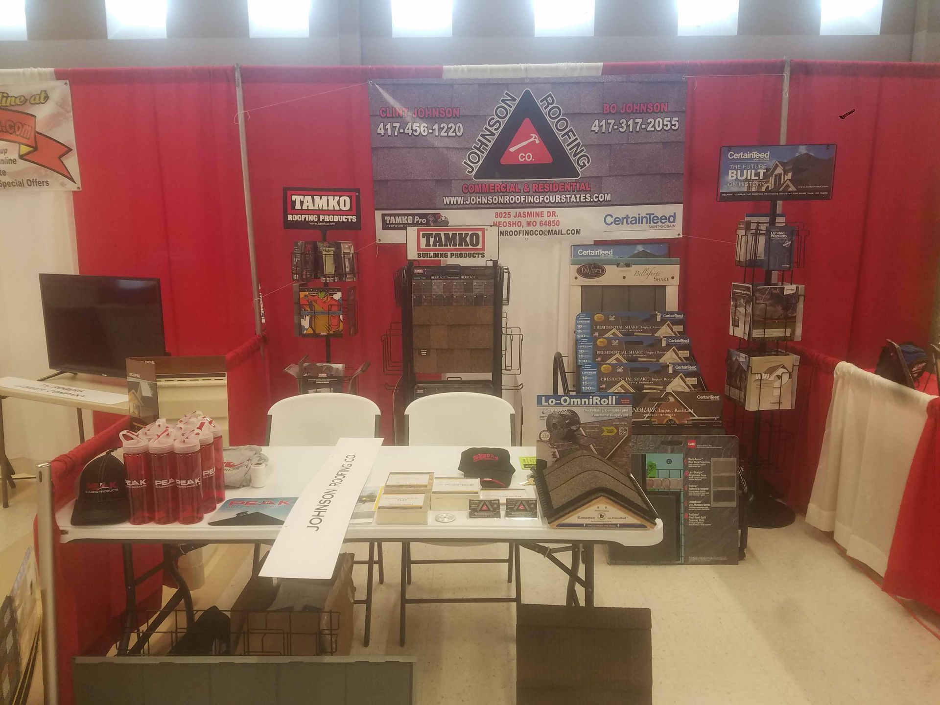 A table and chairs in a room with a sign on the wall.