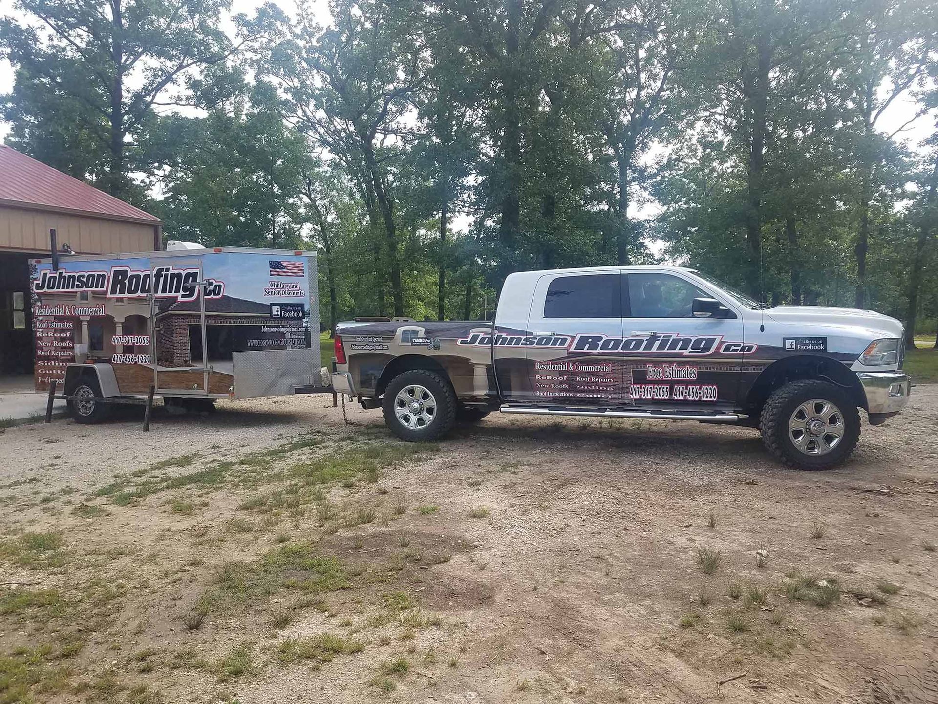 A white truck is parked next to a trailer.