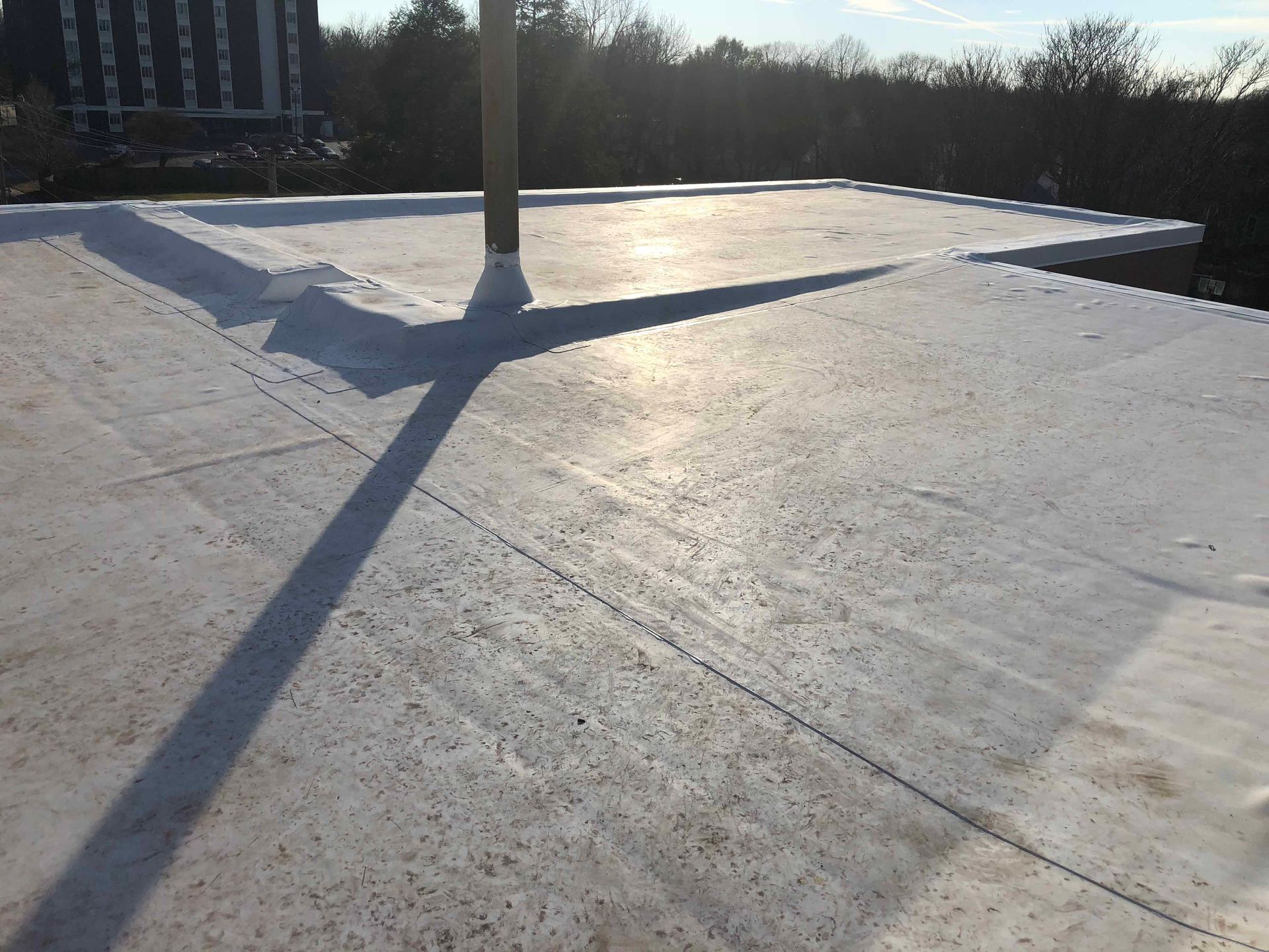 A white roof with a chimney on top of it