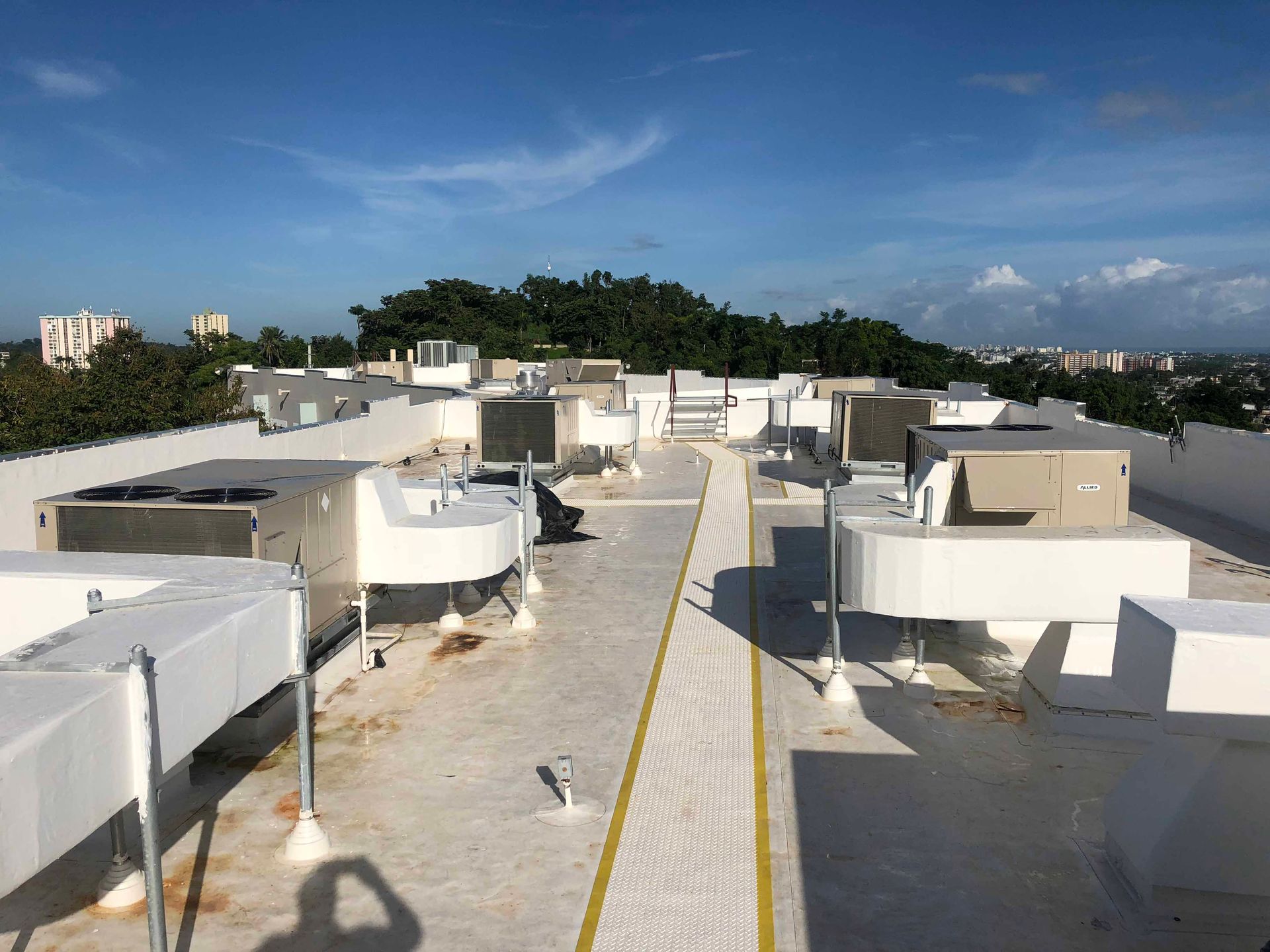 The roof of a building with a lot of air conditioners on it.
