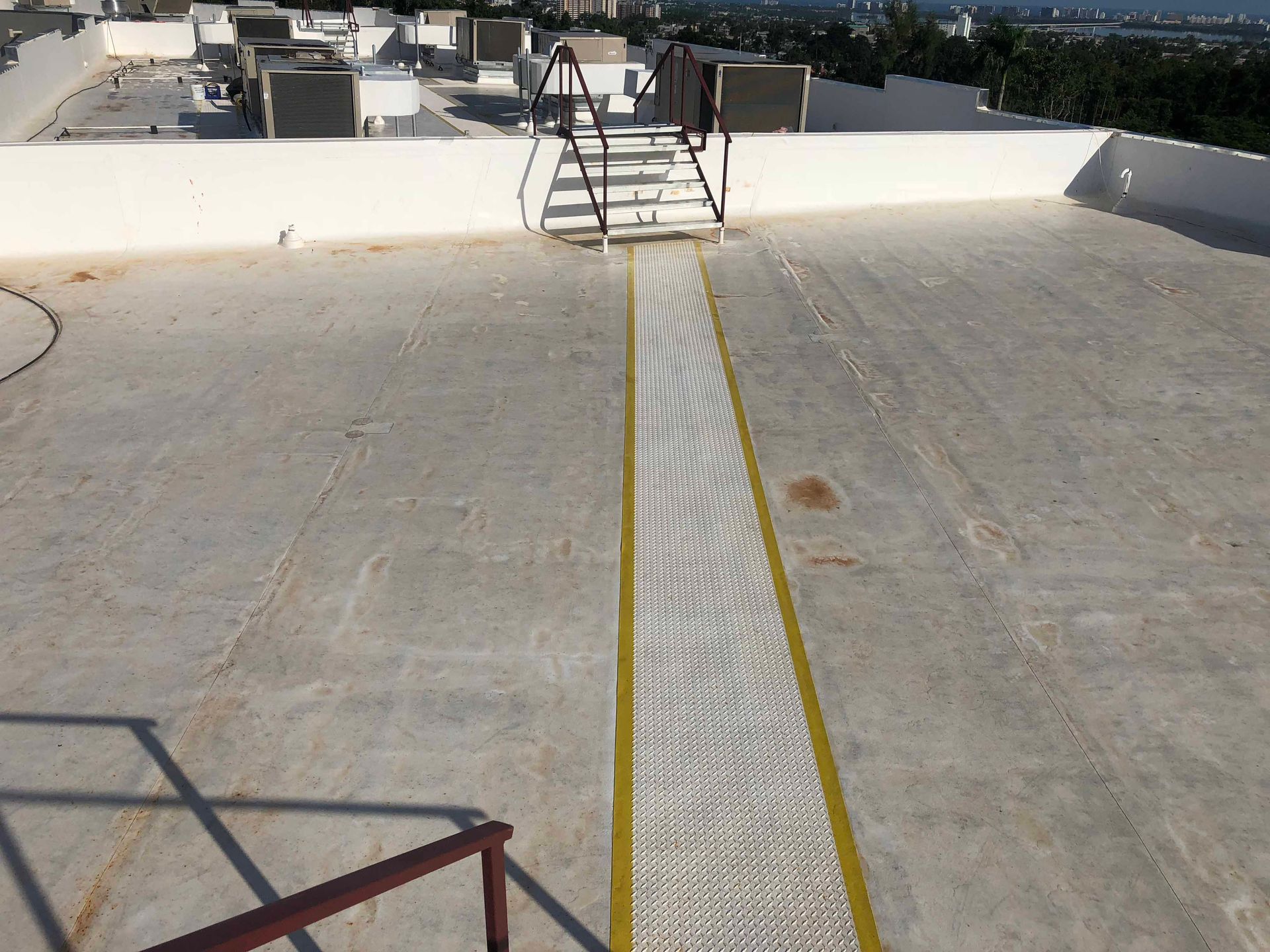 A roof with stairs and a yellow line on it