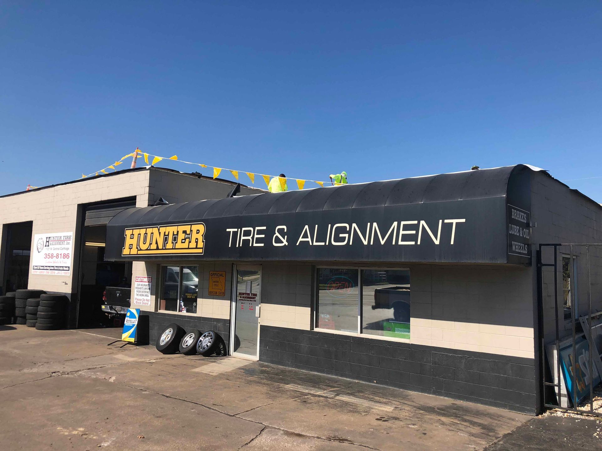 A tire and alignment shop with a black awning.