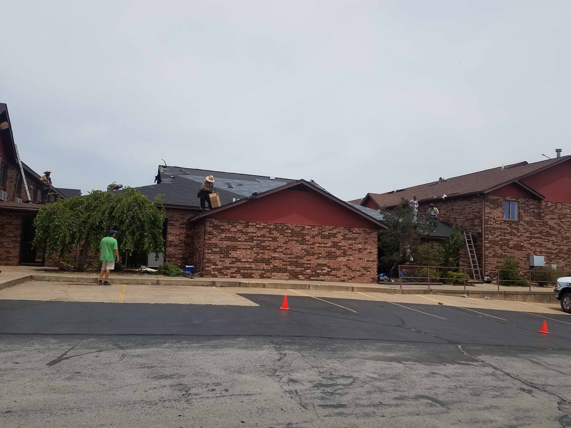 A group of people are working on the roof of a building.