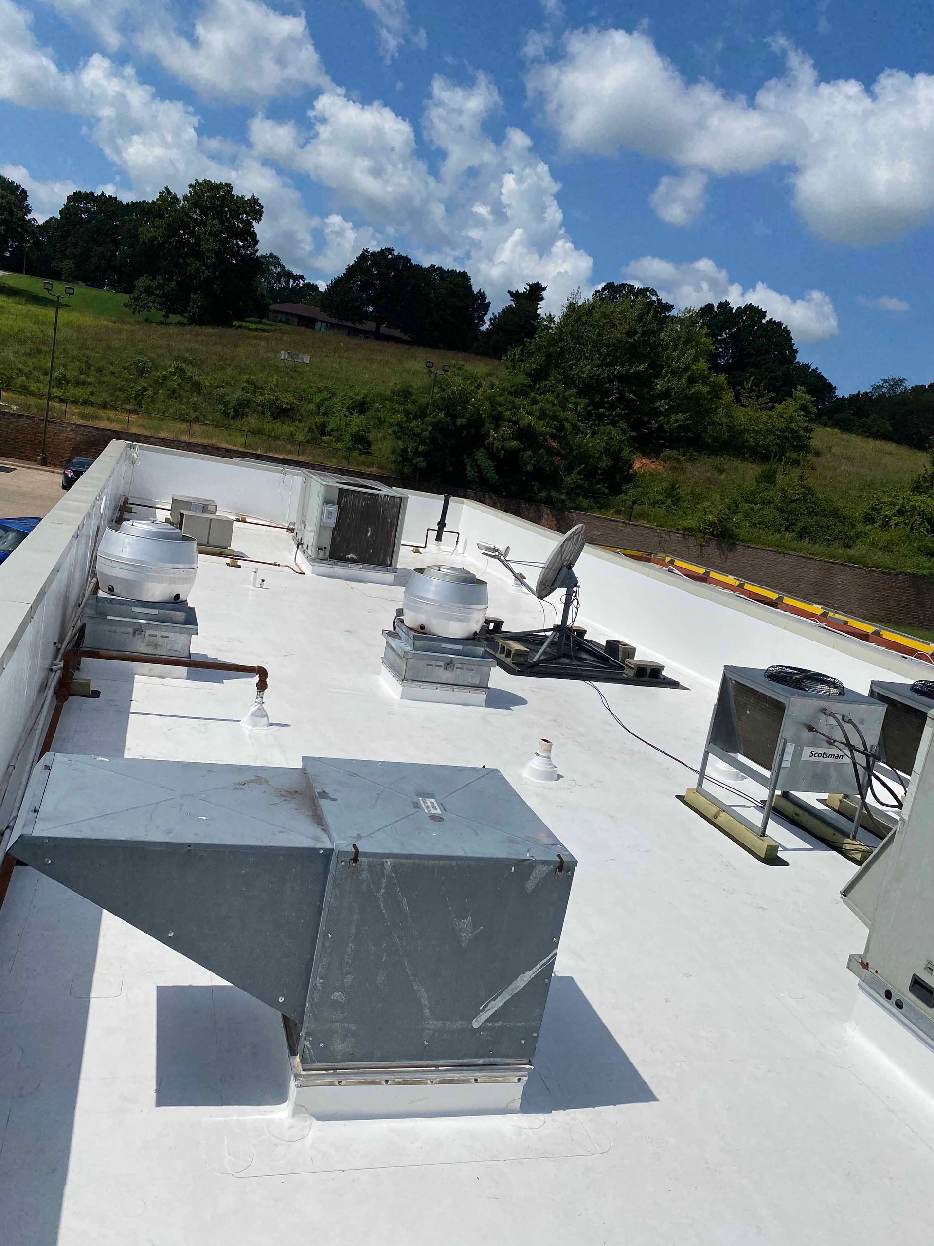 A white roof with a lot of ventilation on it