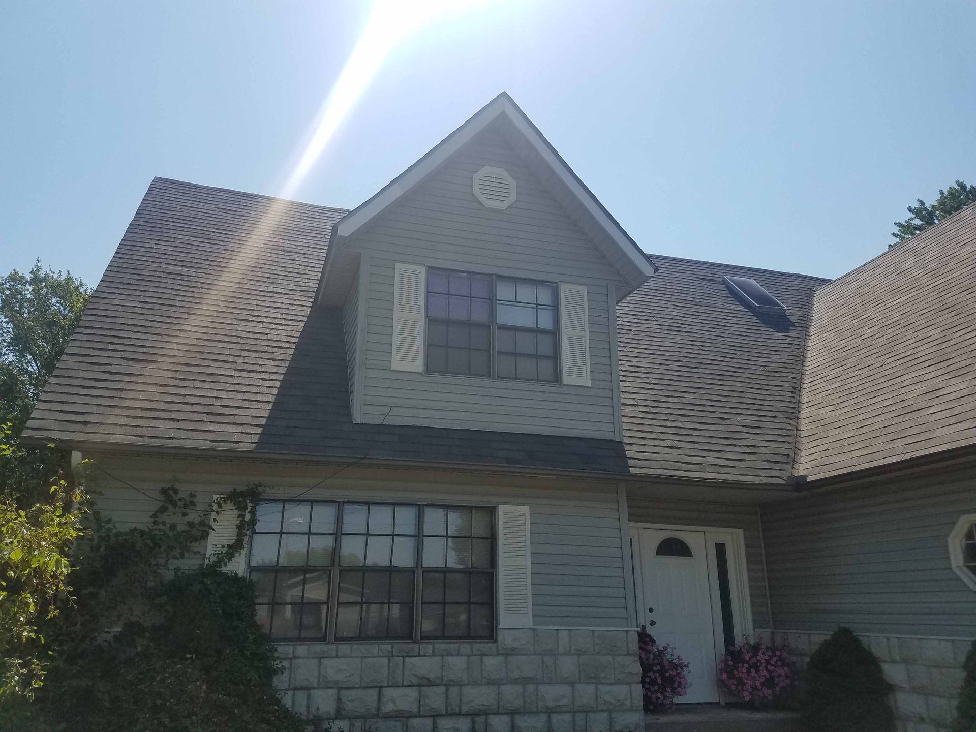 A house with a large roof and a lot of windows.