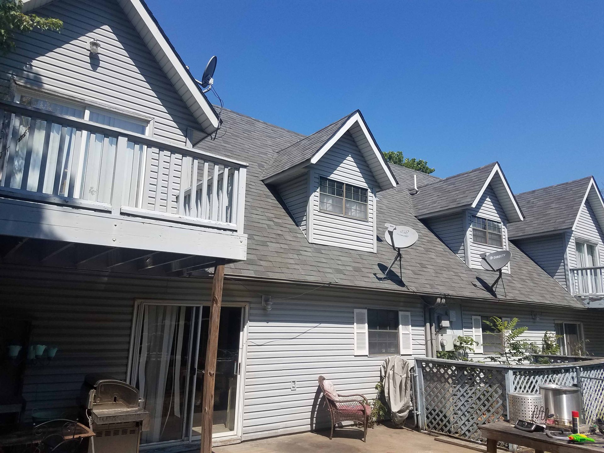 A row of white houses with satellite dishes on the roofs.