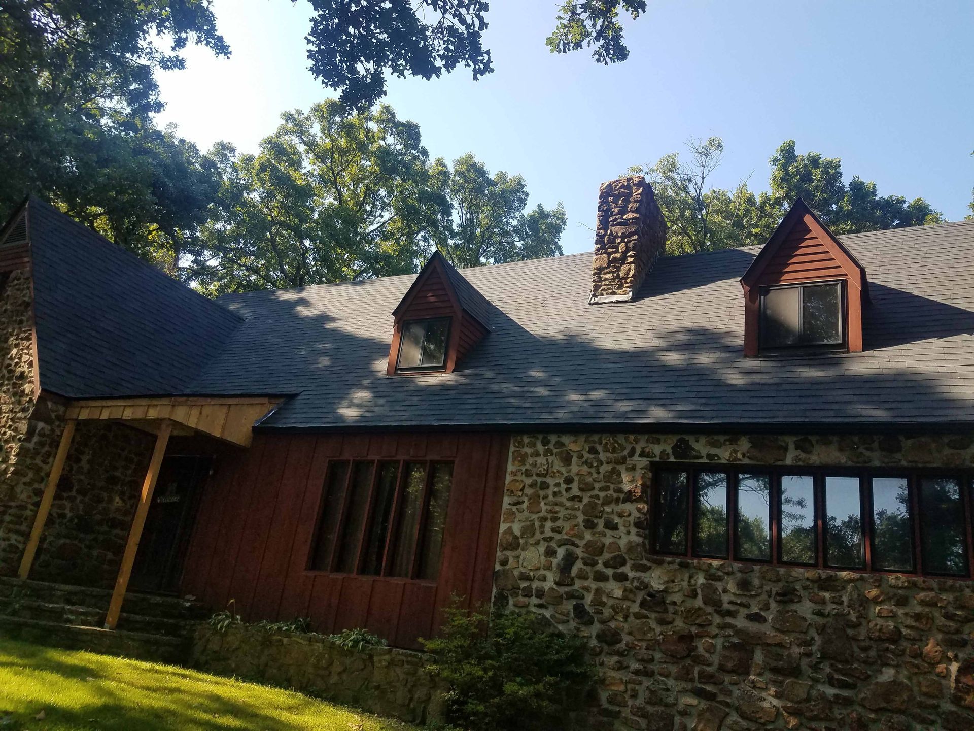 A large stone house with a chimney on the roof