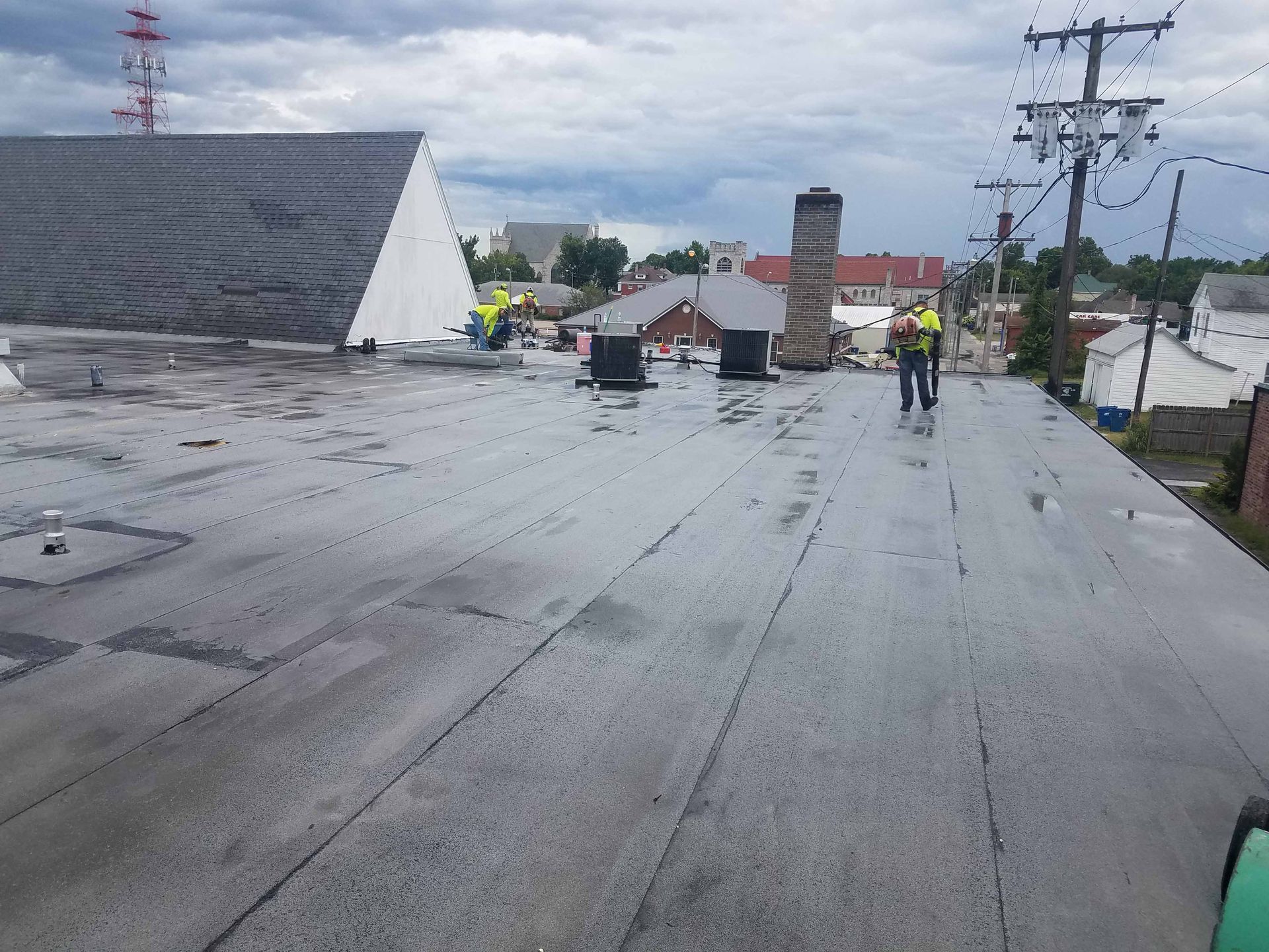 A man is walking on the roof of a building.