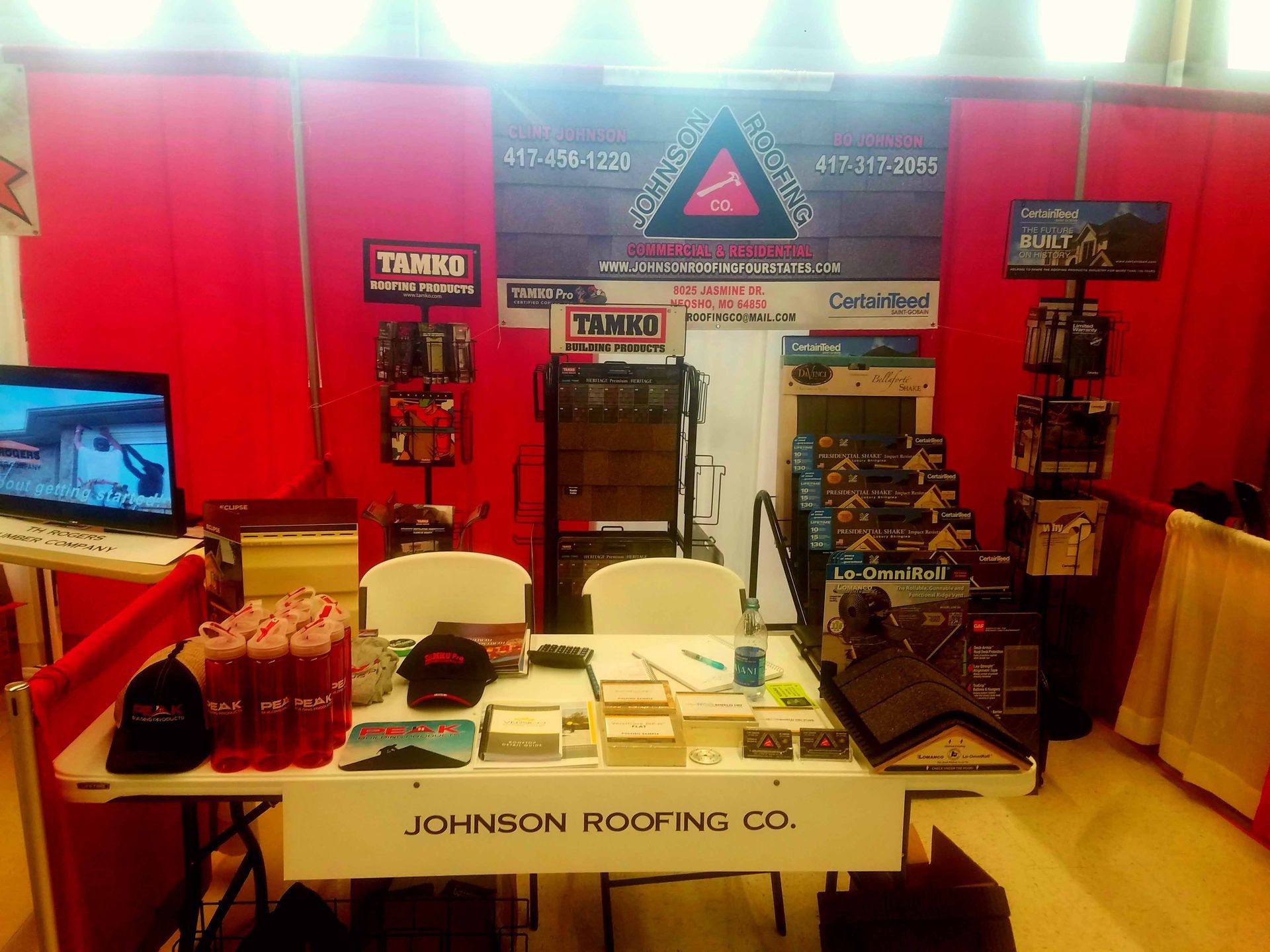 A johnson roofing booth with a table and chairs
