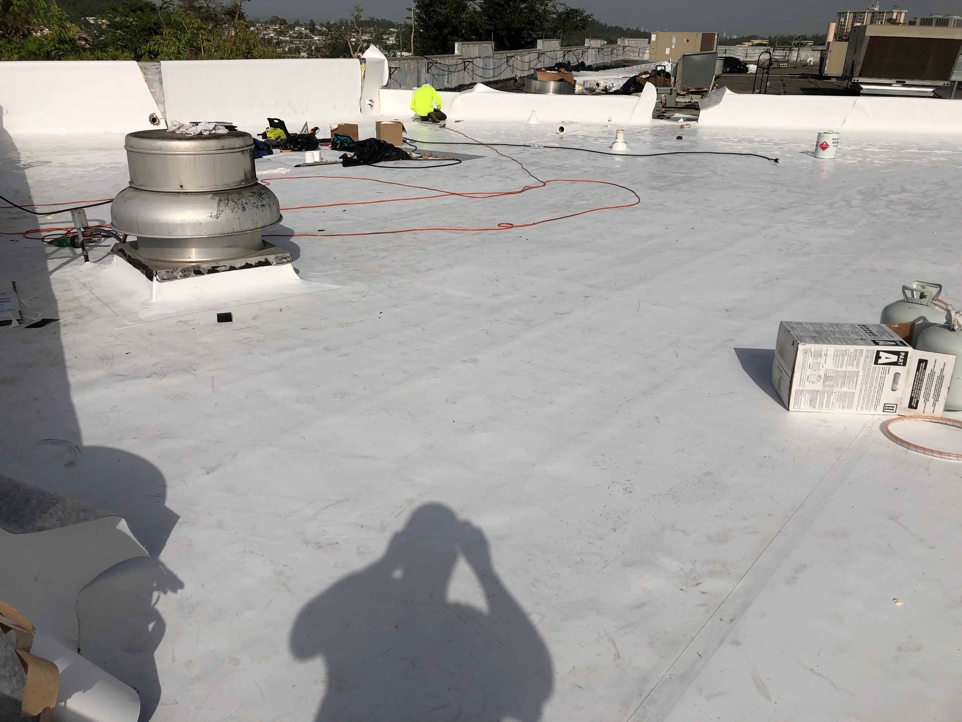 A white roof with a shadow of a person on it.