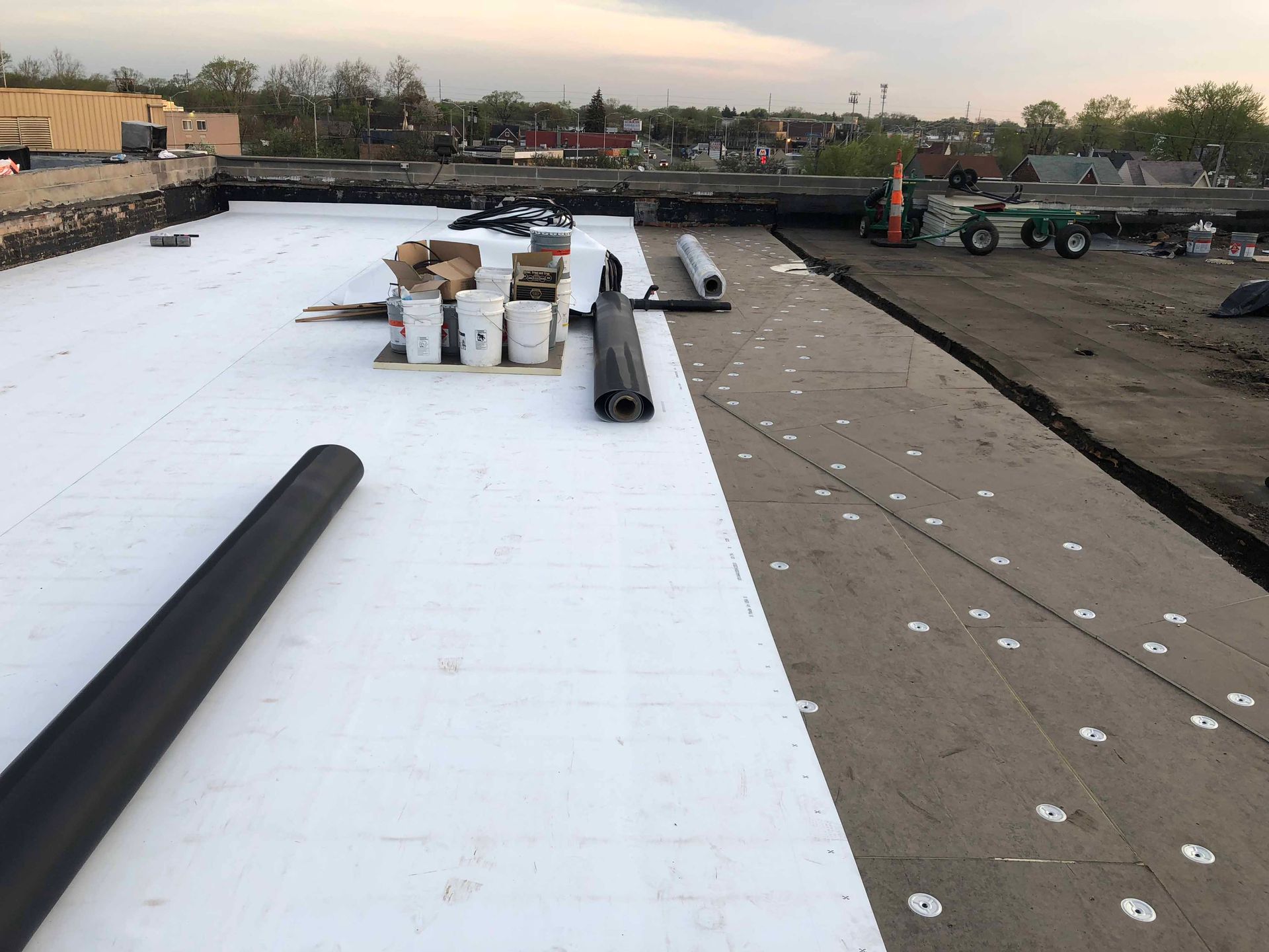 A white roof is being installed on a building.