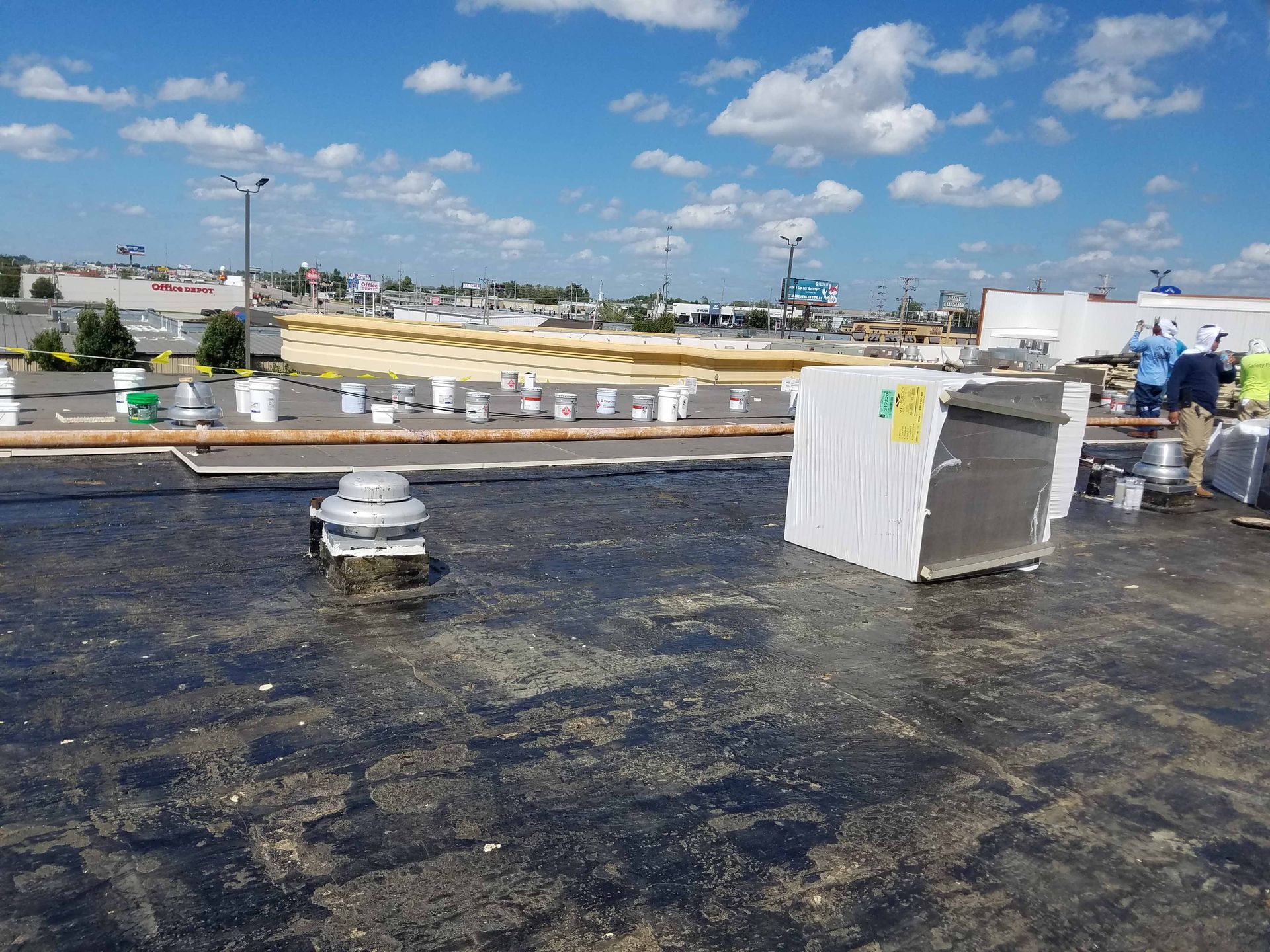A group of people are working on the roof of a building.