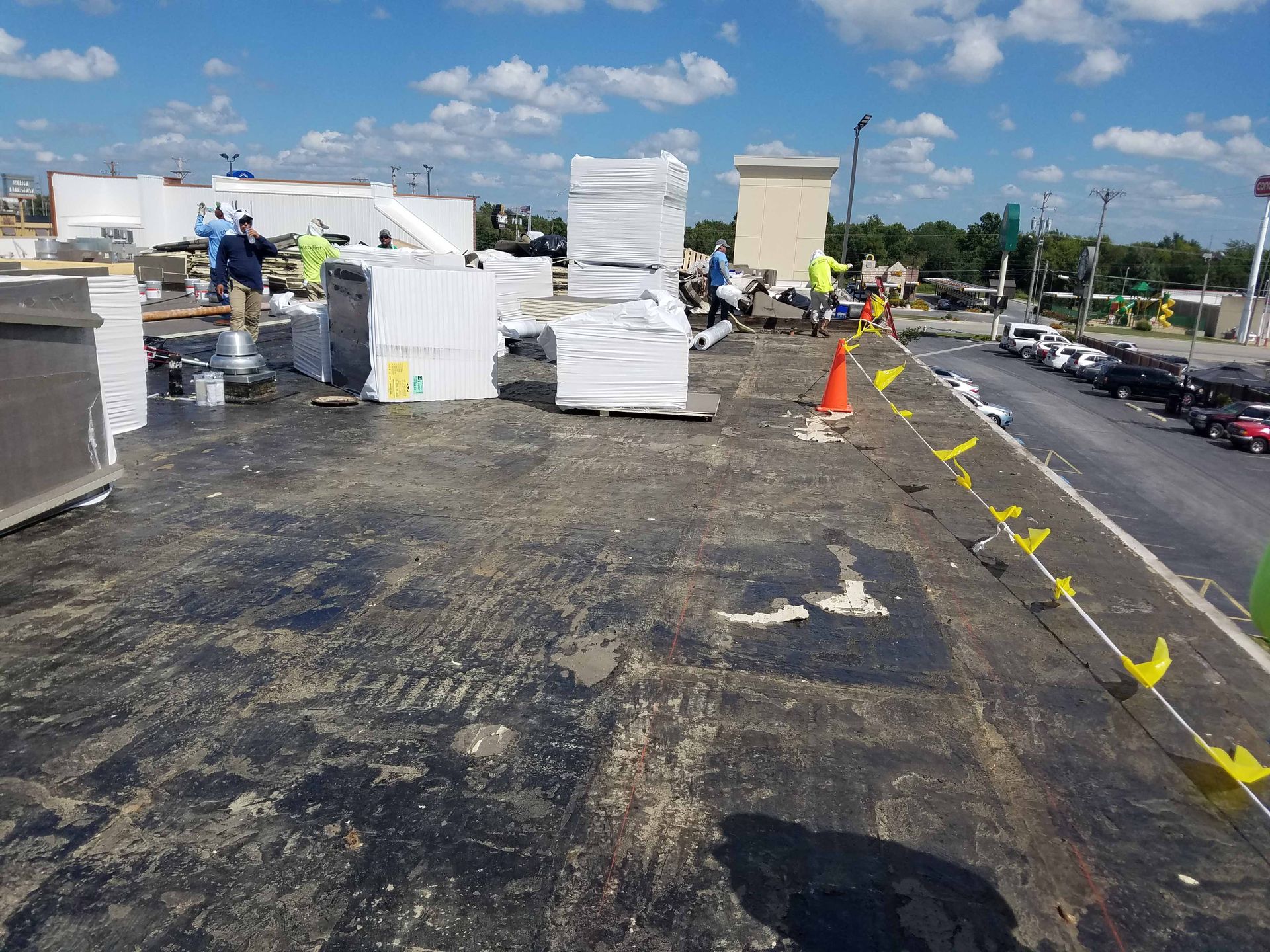 A group of people are working on the roof of a building.