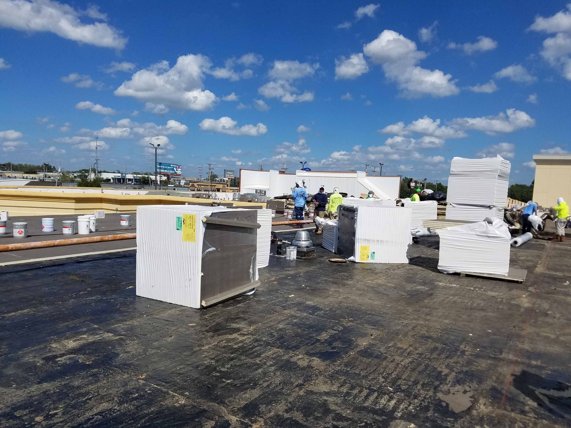 A group of people are working on the roof of a building.