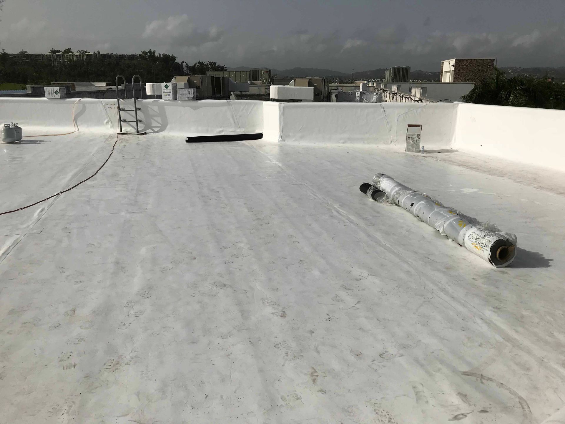 A white roof with a ladder on top of it.