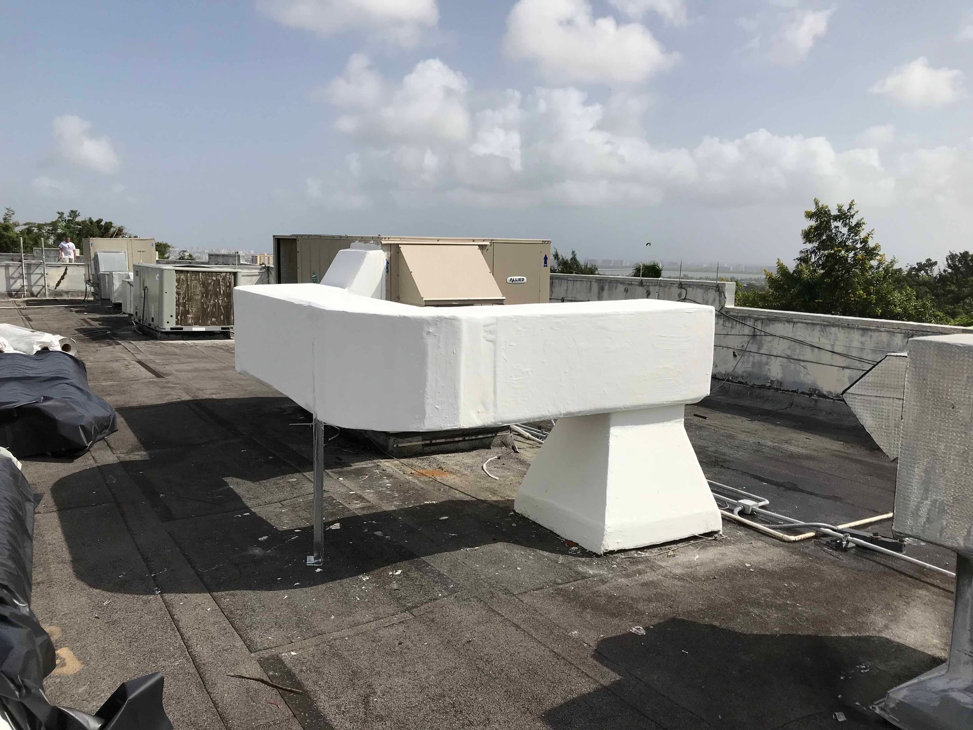 A large white box is sitting on top of a roof.