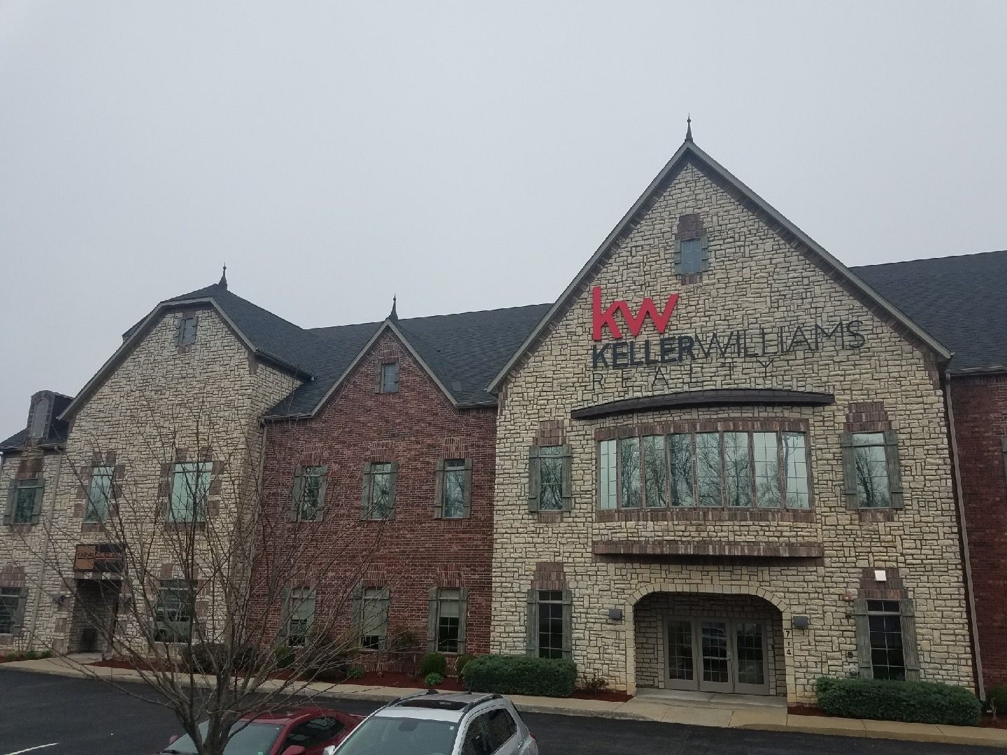 A large brick building with a car parked in front of it.