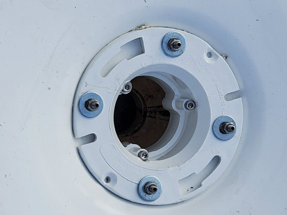 A close up of a white circle with screws on it.