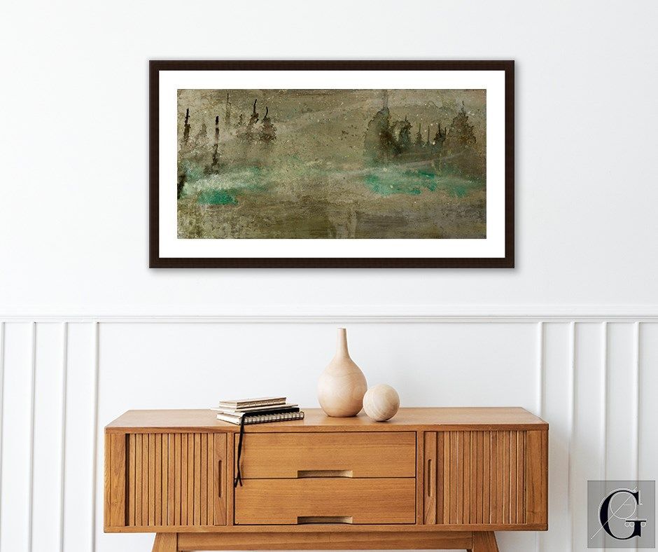 Abstract painting of trees and water, framed over a wooden cabinet with vases.