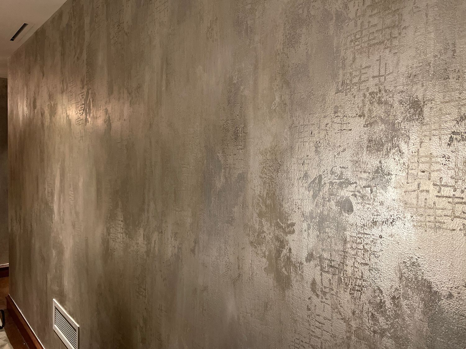 Textured gray wall with a metallic sheen.