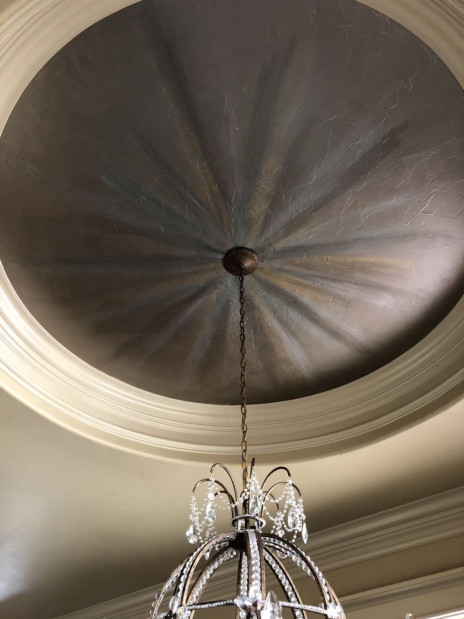 Ornate ceiling with radial pattern and chandelier.
