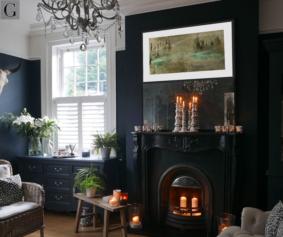 Dark room with a black fireplace, artwork, candles, and a crystal chandelier; natural light from the window.