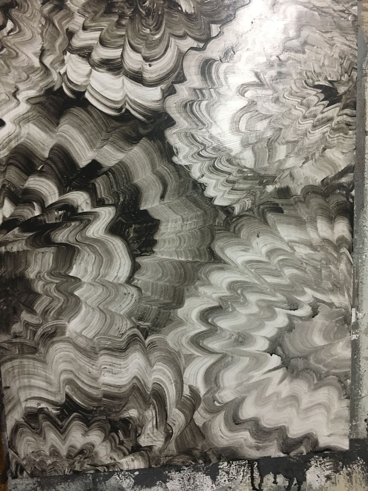 Abstract black and white painting with swirling brushstrokes creating floral-like patterns.
