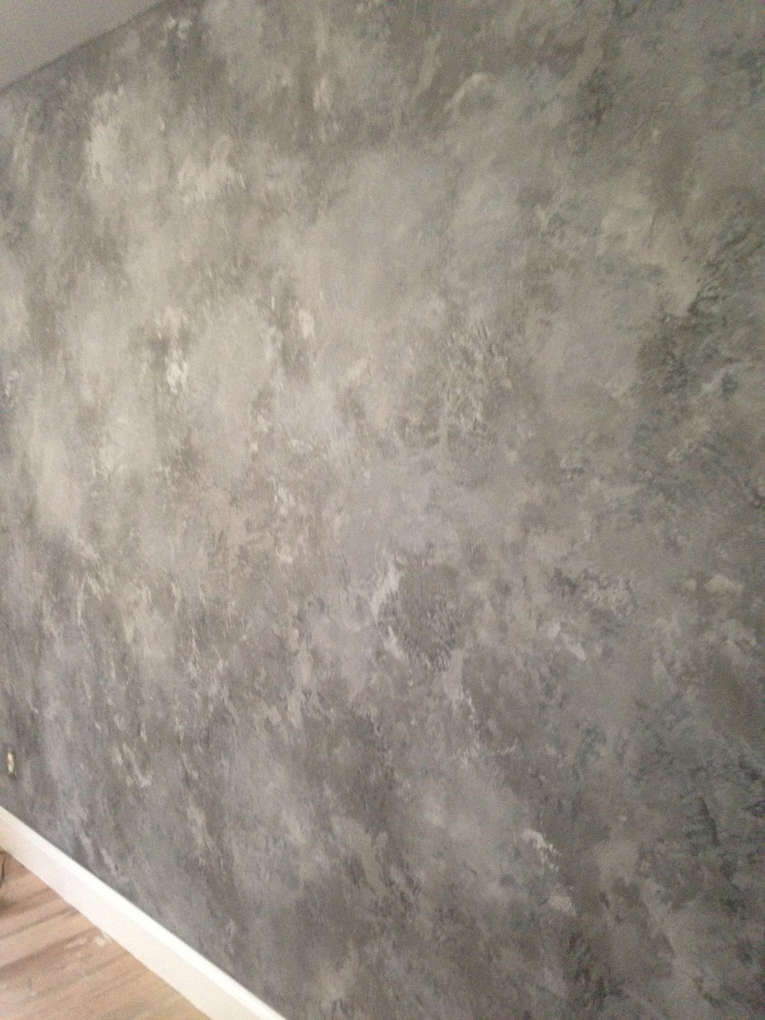 Gray and white mottled wall with a textured, cloudy appearance.