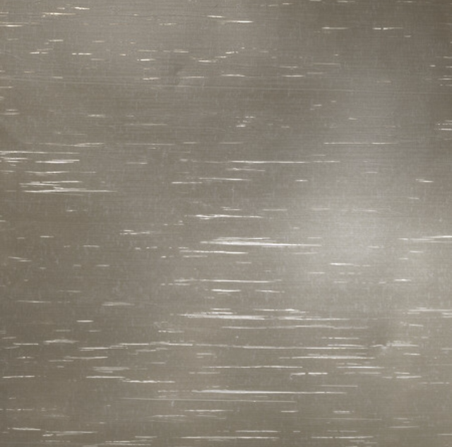 Brushed metal surface with horizontal and random scratches, silver-gray tone.