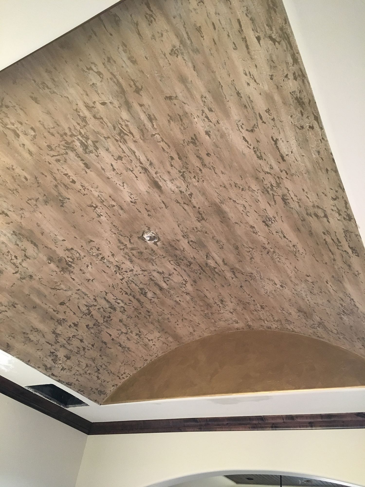 Textured, arched ceiling with beige and brown paint.