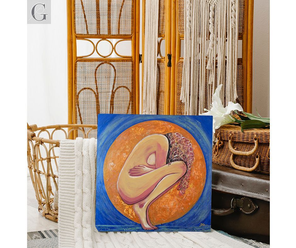 Painting of a nude figure in fetal position, within an orange circle, on a blue background. Wooden cabinet behind.