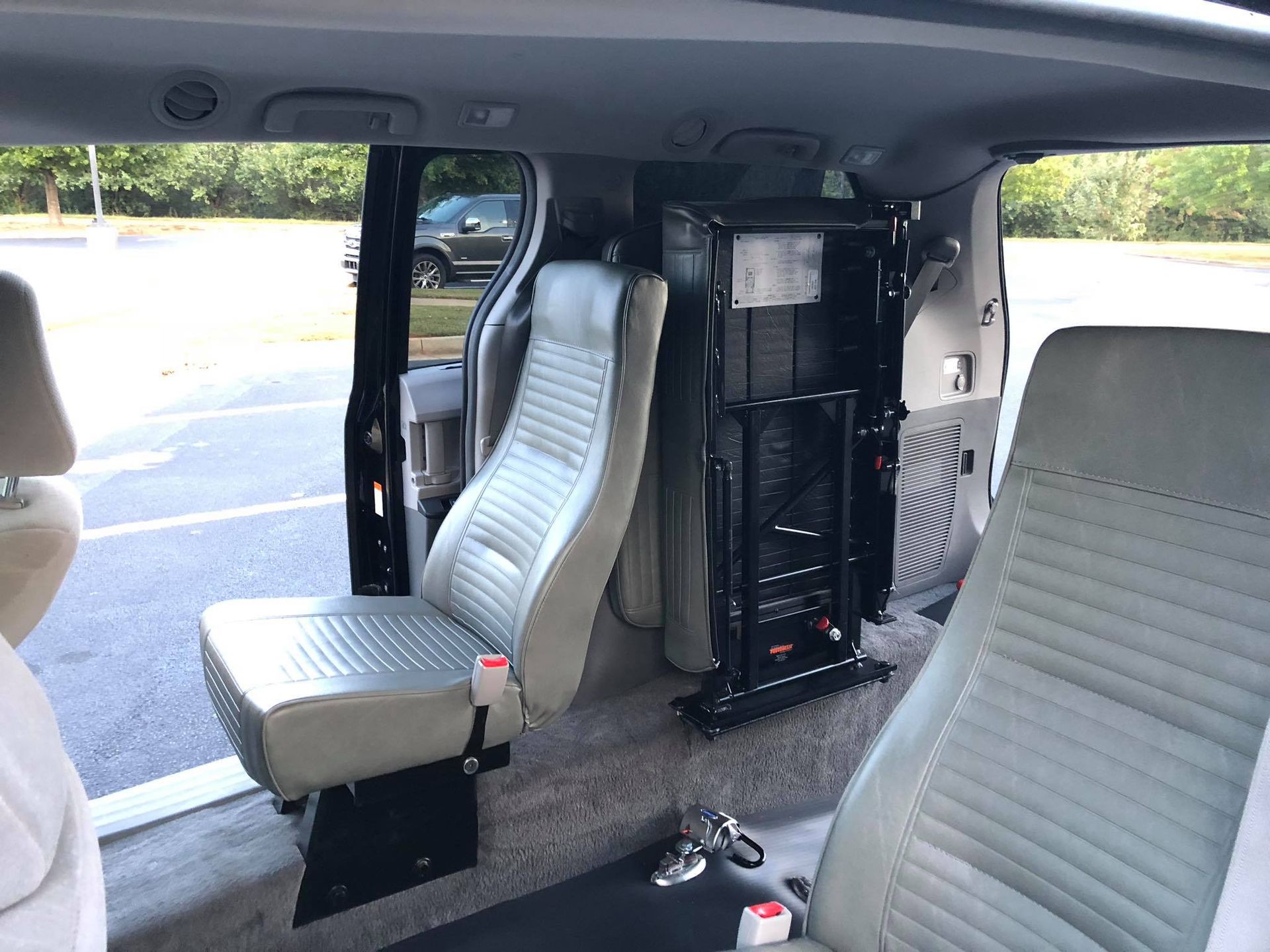 Interior of accessible van with seats and wheelchair lift.