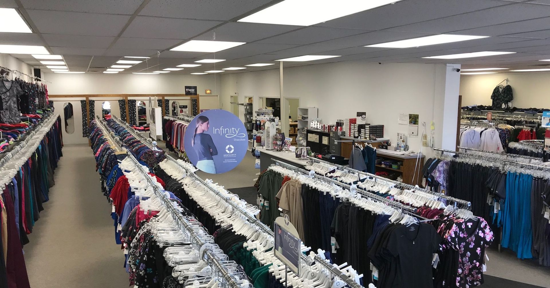 A large clothing store filled with lots of clothes hanging on racks.