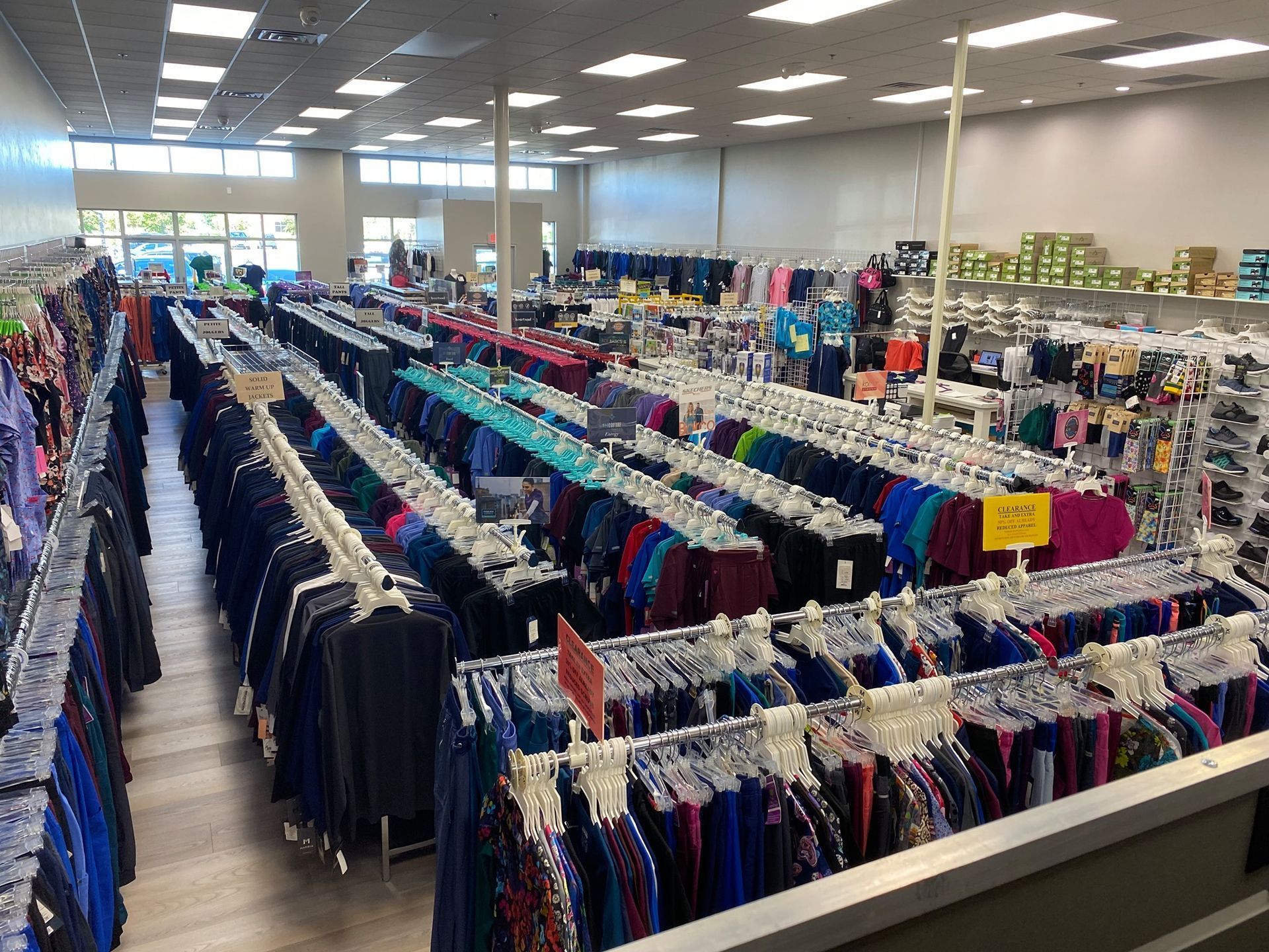 A large store filled with lots of clothes and shoes.