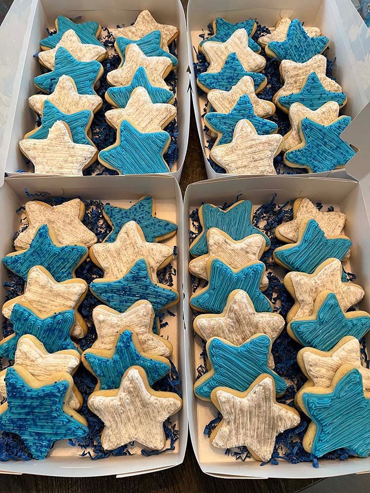 a box filled with blue and white star-shaped cookies