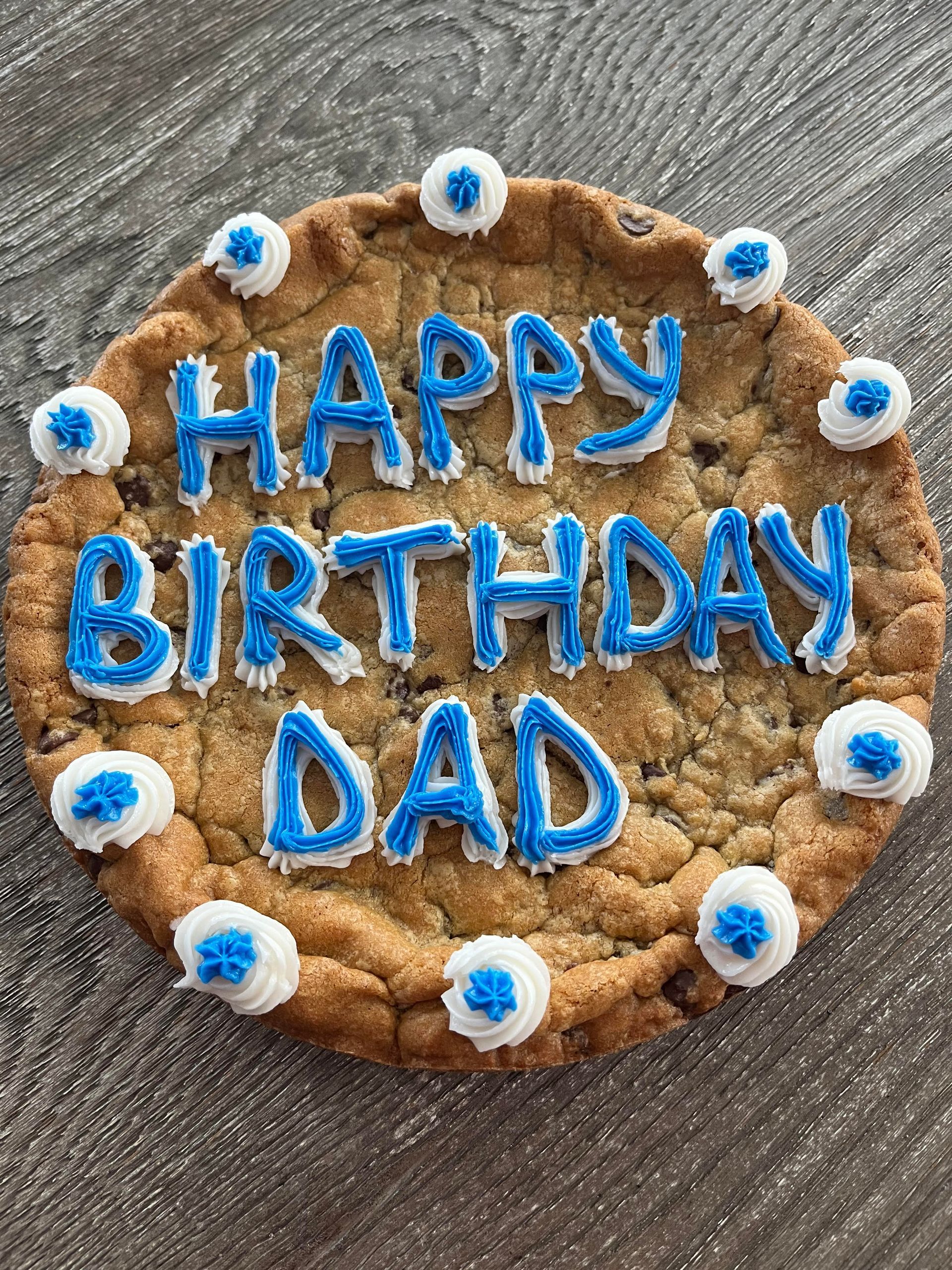 a cookie with blue frosting and sprinkles that says